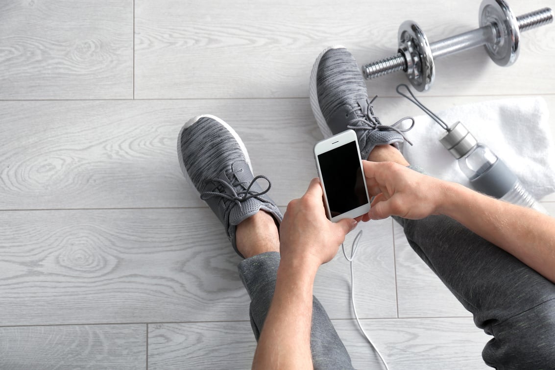 Man Using Smartphone in Gym